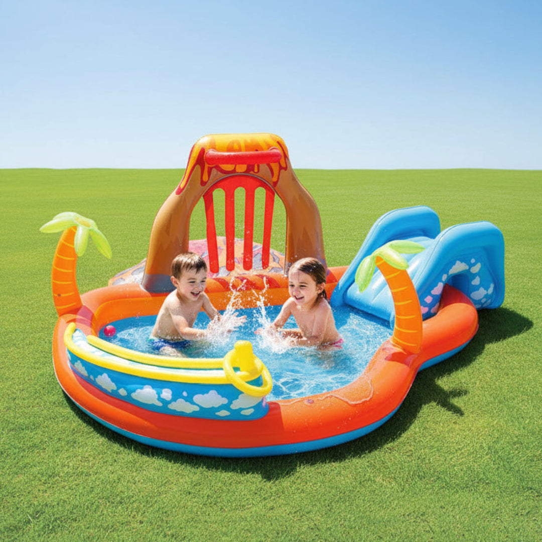 Children playing in a colorful inflatable pool with a slide on a grassy field.