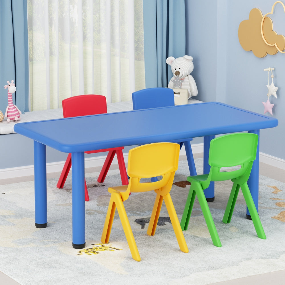 Colorful children's table and chairs set in a room with blue walls and white curtains.
